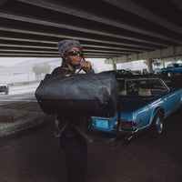 BLACKED OUT EMBOSSED GOLD TOOTH DUFFLE